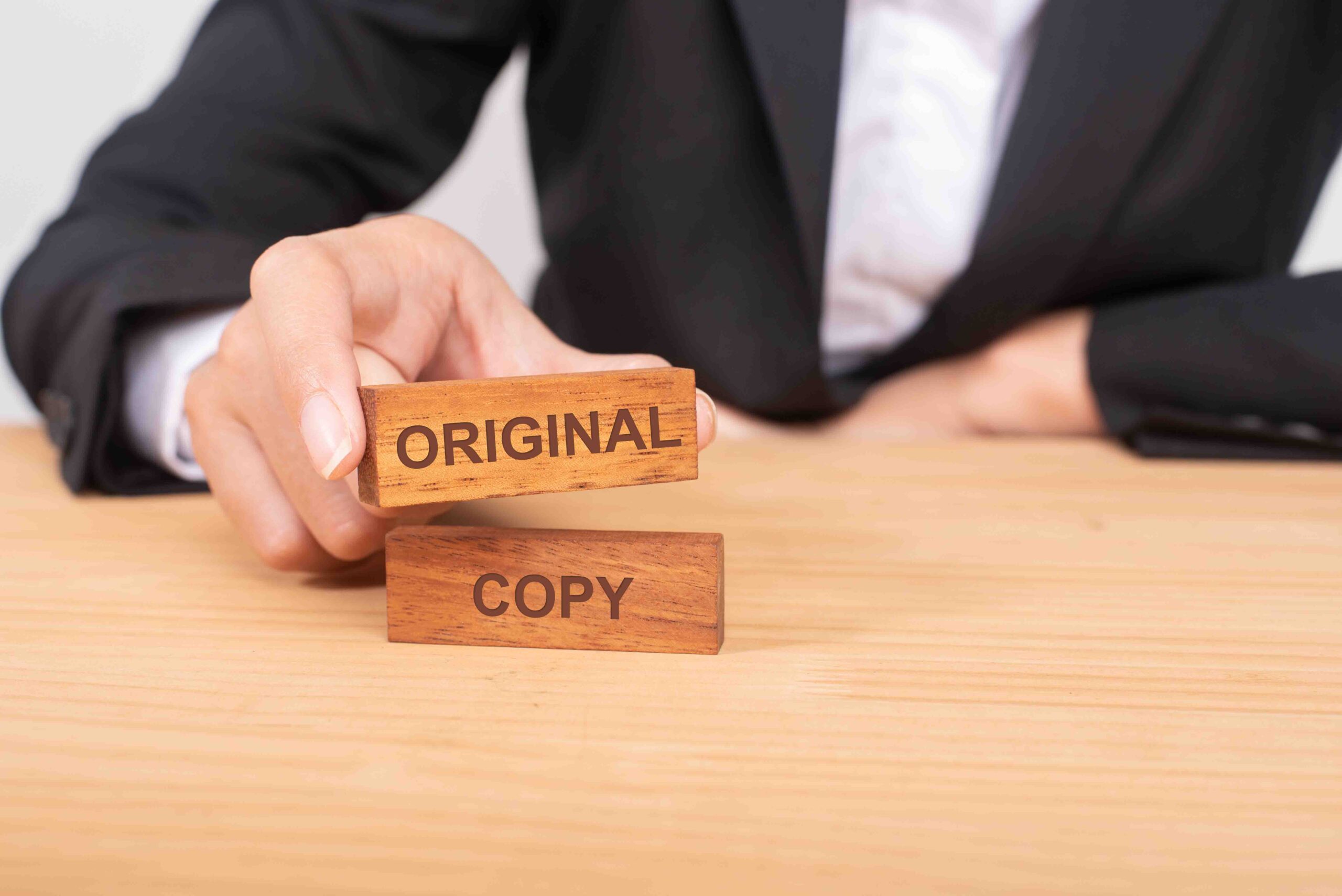 Hand of businessman choosing wood blog with icon and word Origin AdobeStock 216911237 scaled